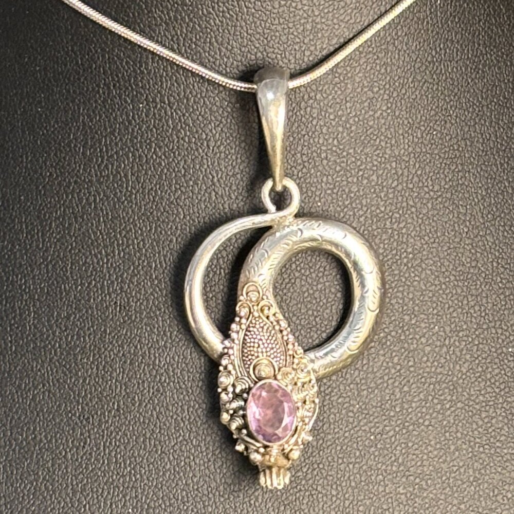 Ornate Balinese silver cobra snake pendant with faceted pale amethyst stone